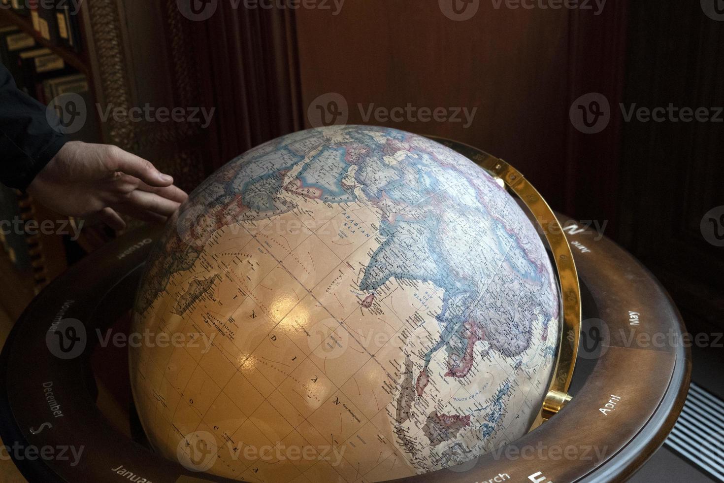 Hand touching earth globe photo