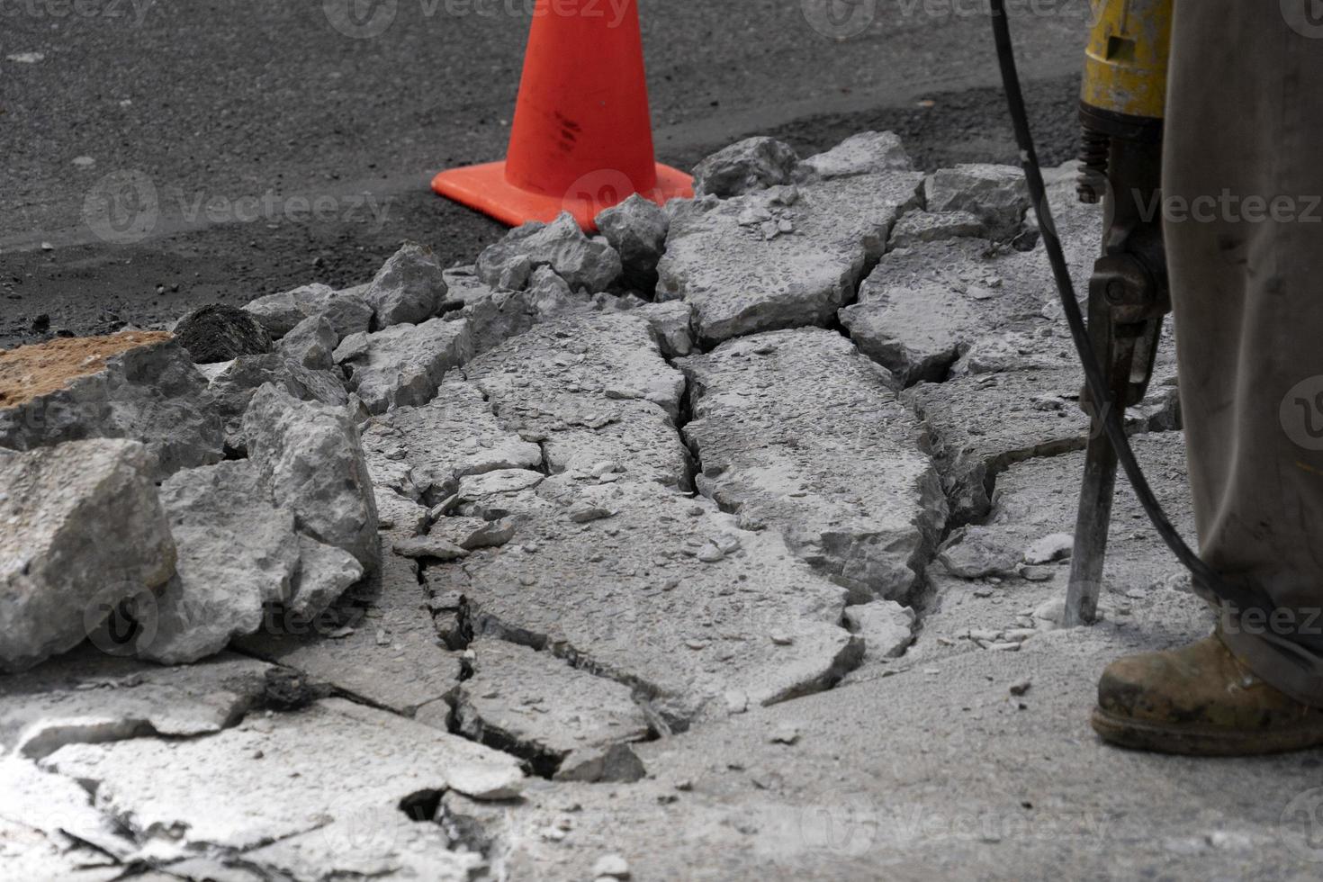 Man working with jackhammer on the road photo