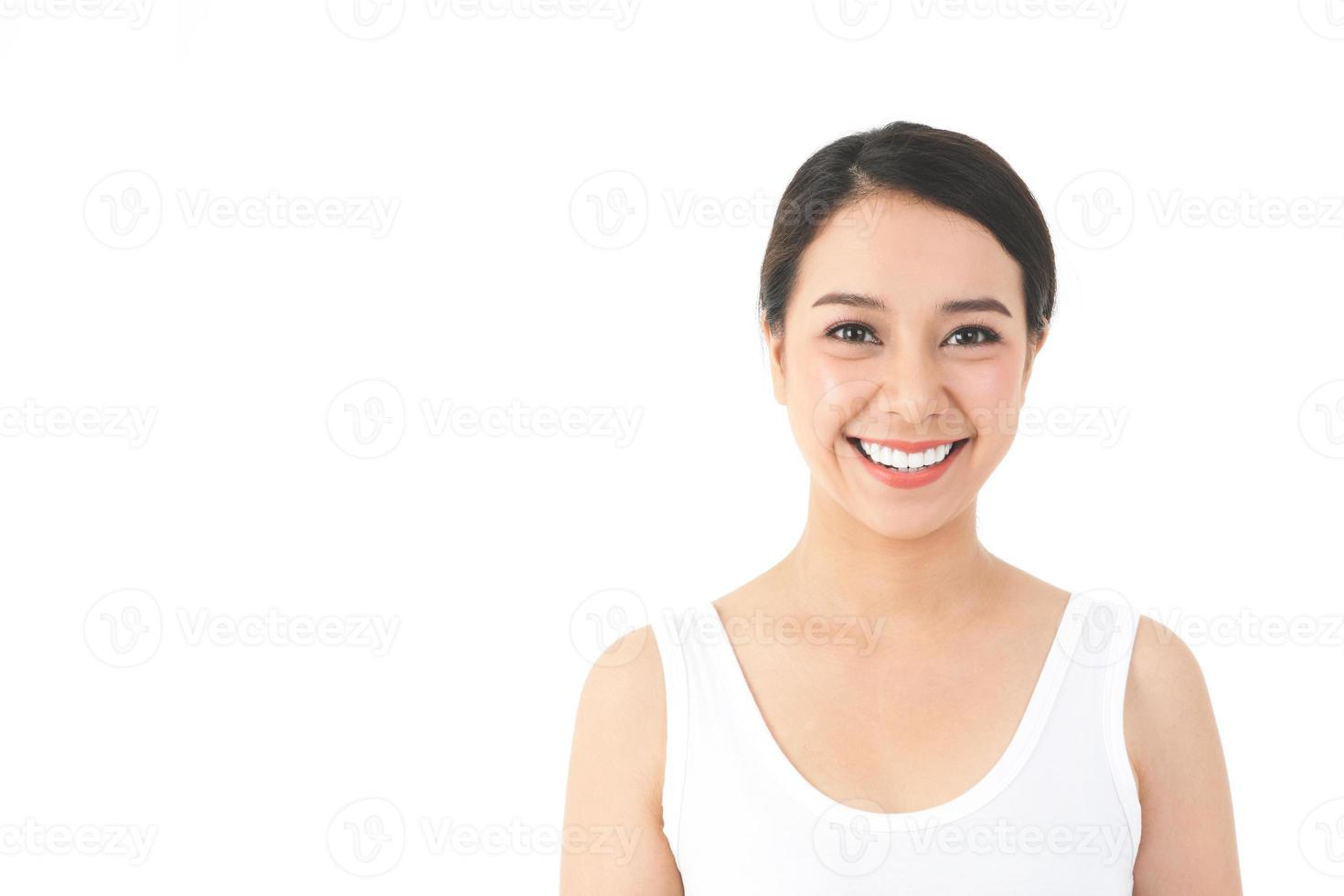 An Asian woman with a beautiful and young smile and good skin. Clean and healthy. Beauty concept.  with copy space. White background photo