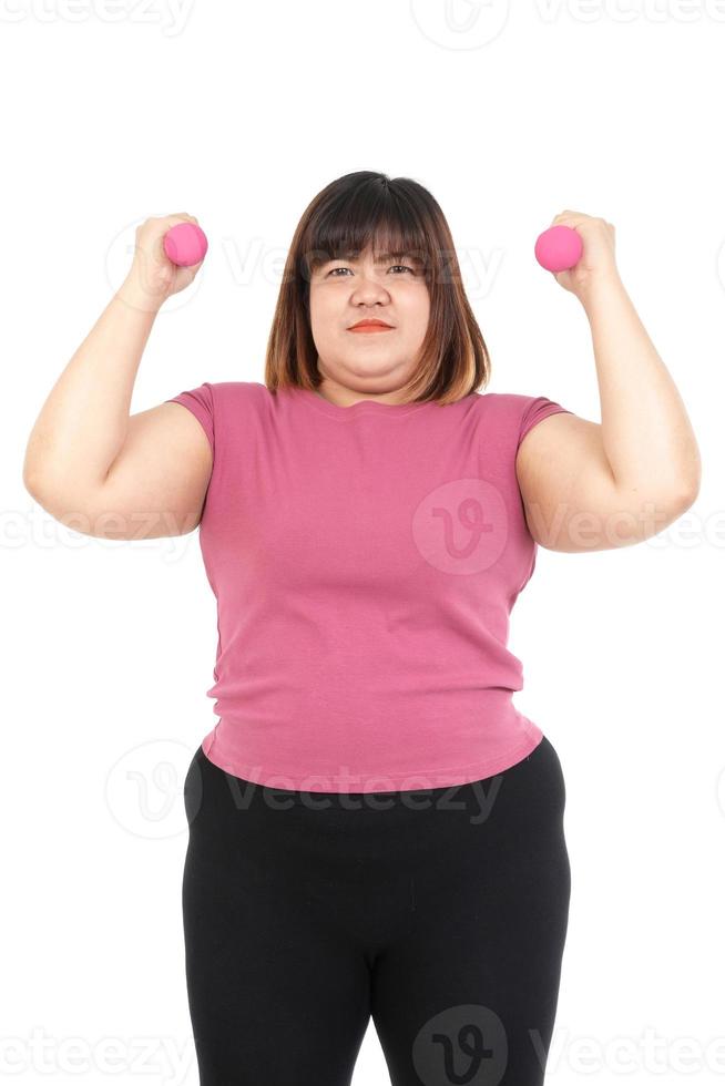 Portrait, fat Asian woman wearing exercise clothes lifting pink dumbbell Stay on a white background. Concept of weight loss, fat burning, exercise to stay healthy. photo