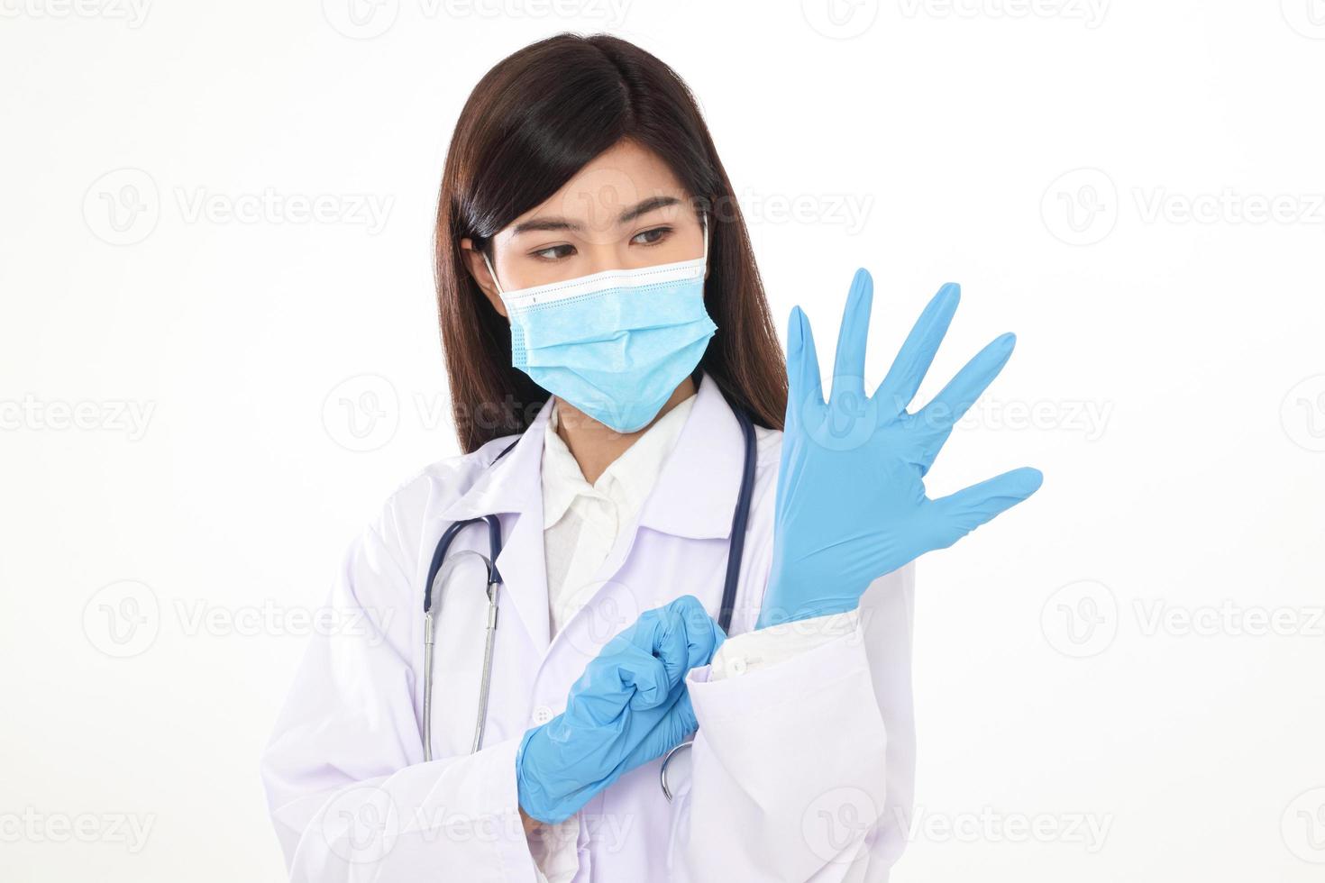 A beautiful Asian woman doctor wearing a blue mask and gloves to prevent infection. And coronavirus photo
