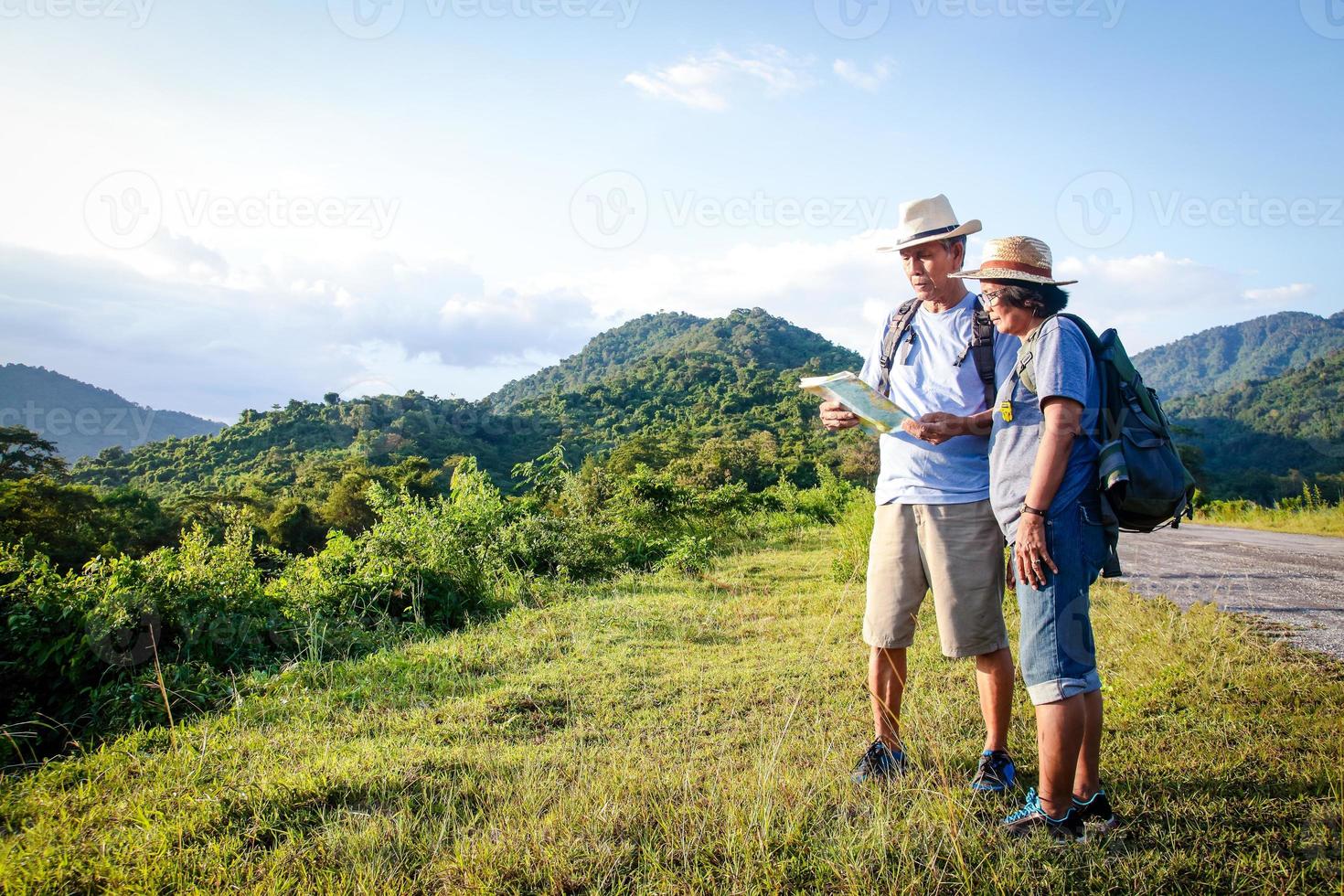 Senior Asian Couple Trekking, traveling, living a happy life in retirement Healthy, can see the fresh nature. The concept of health tourism for the elderly. with copy space. photo