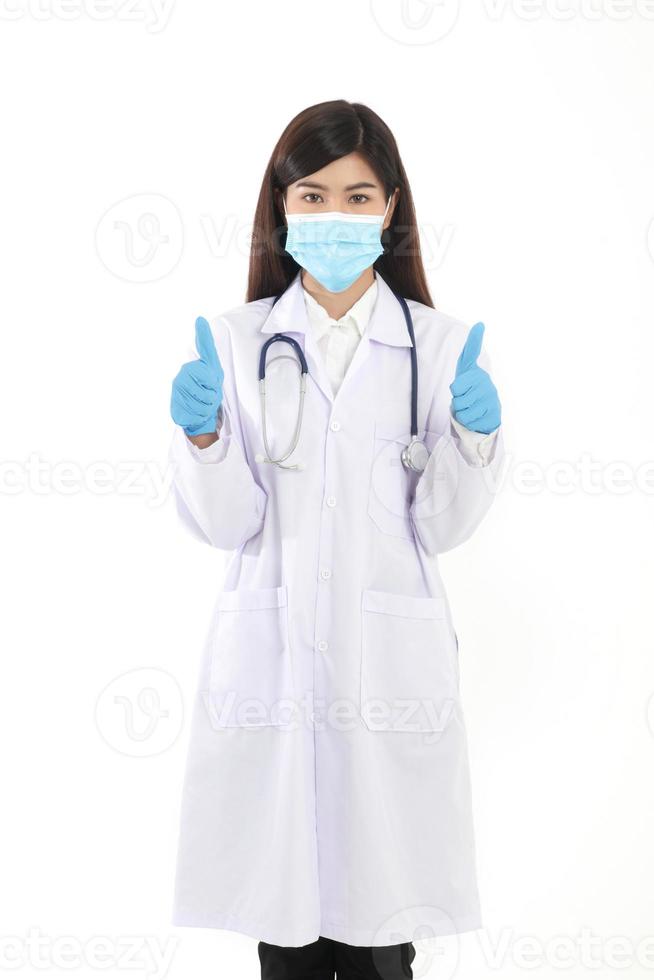 A beautiful Asian woman doctor wearing a blue mask and gloves to prevent infection. photo