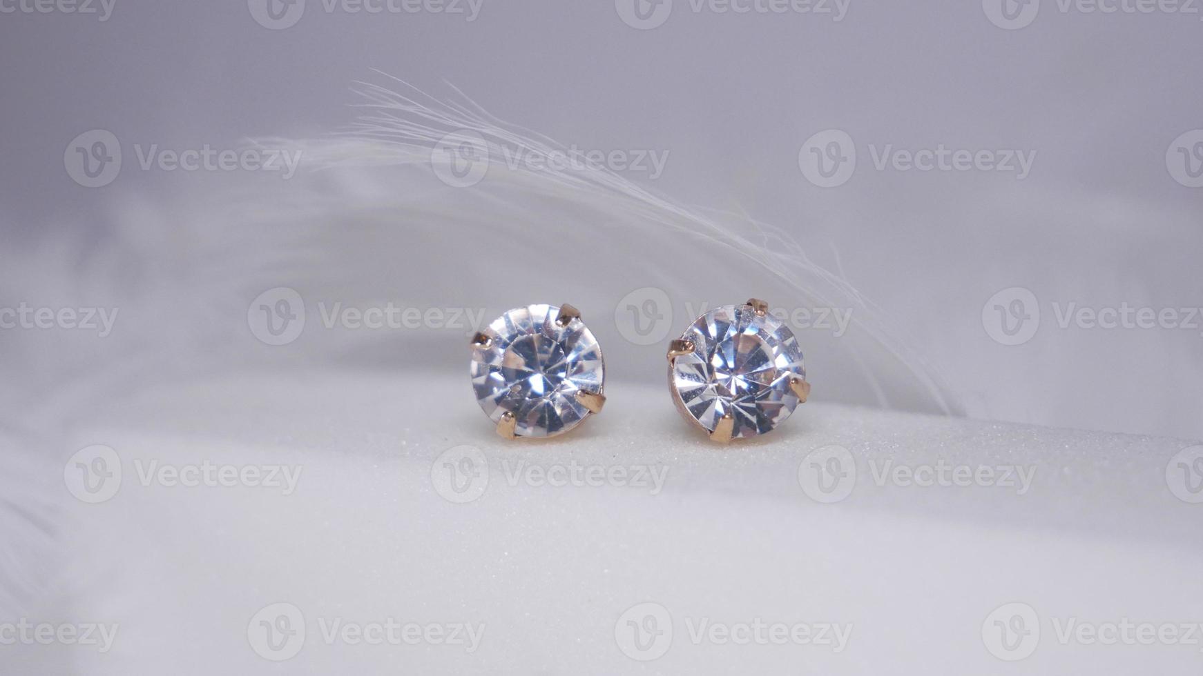 Beautiful gold earrings close-up on a white background photo