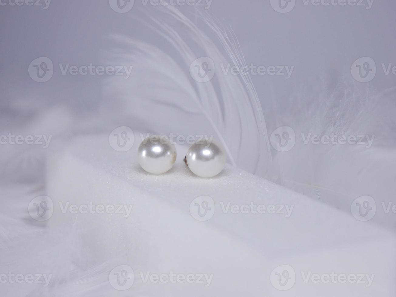 Beautiful gold earrings close-up on a white background photo