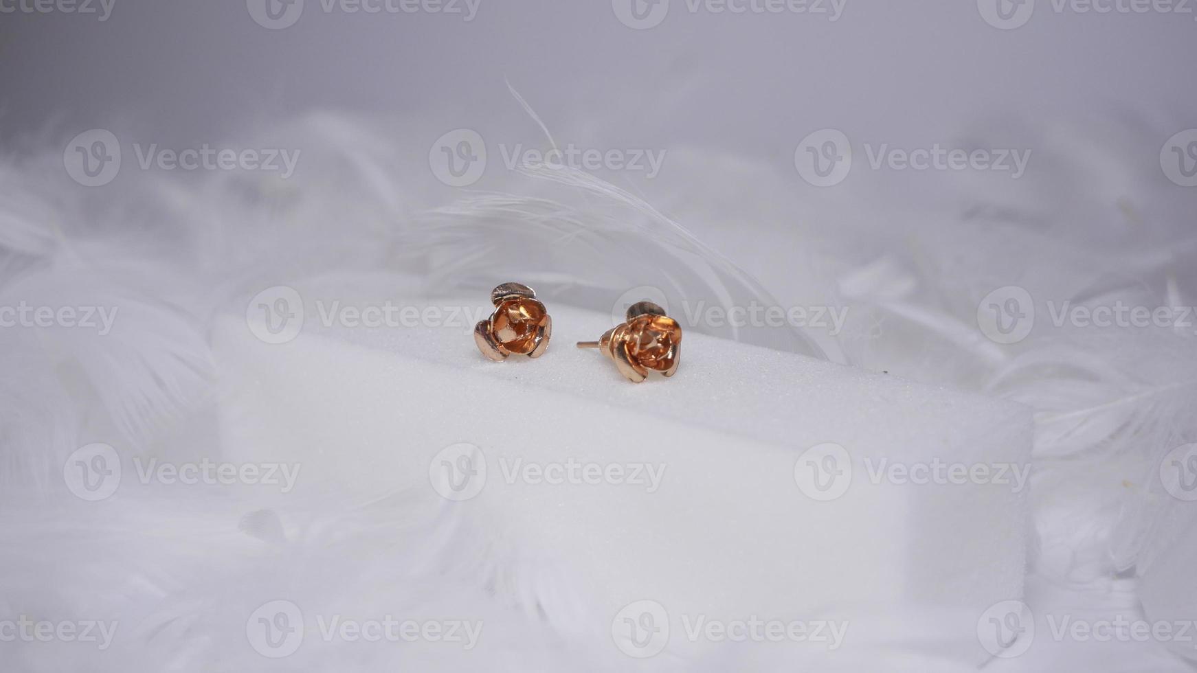 Beautiful gold earrings close-up on a white background photo