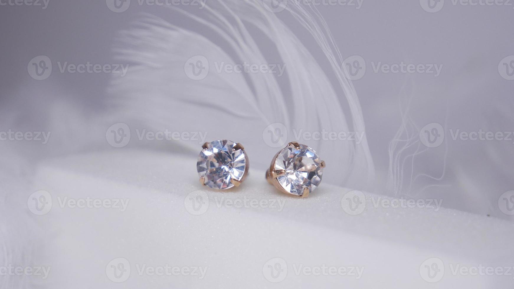 Beautiful gold earrings close-up on a white background photo