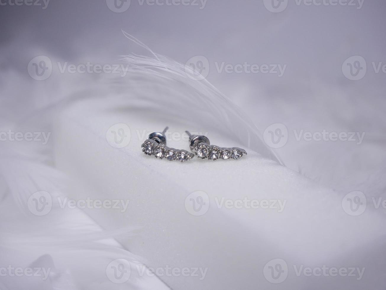 Beautiful gold earrings close-up on a white background photo