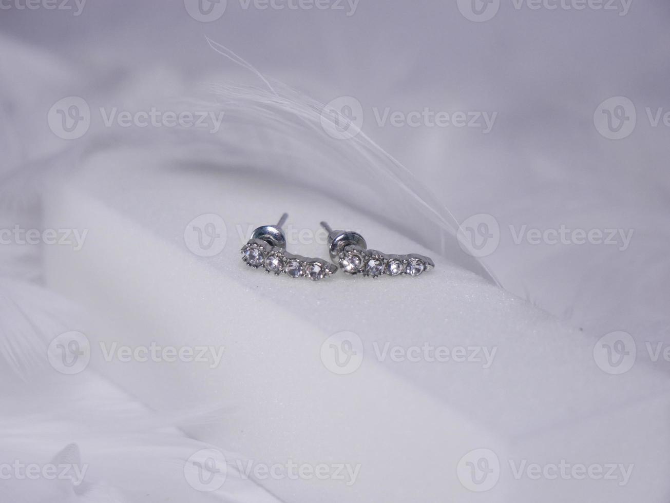 Beautiful gold earrings close-up on a white background photo