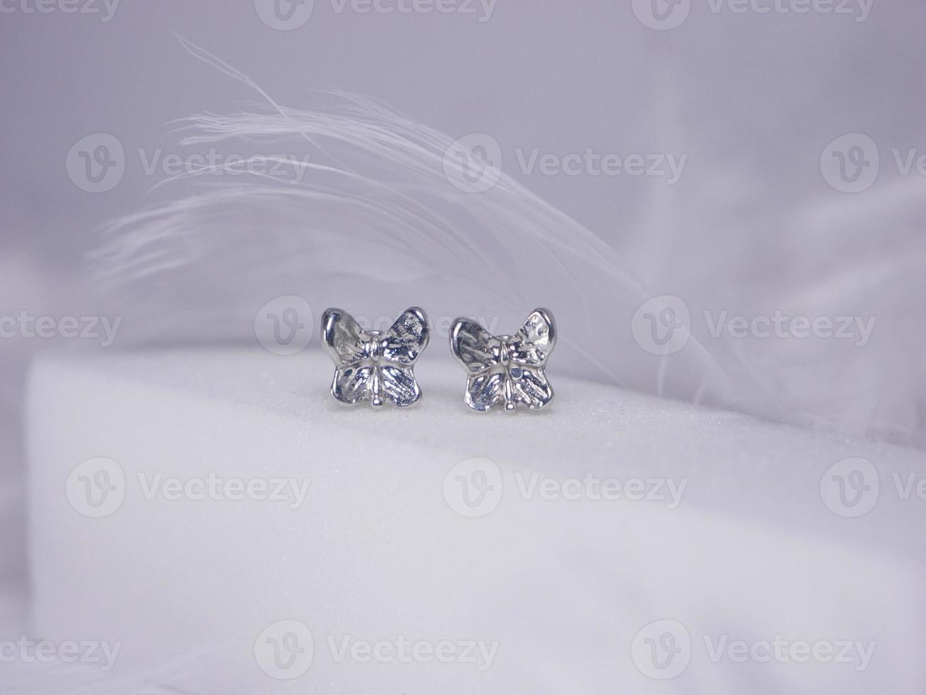 Beautiful gold earrings close-up on a white background photo