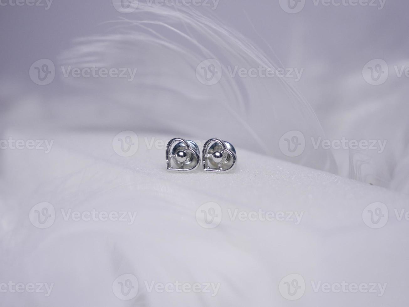 Beautiful gold earrings close-up on a white background photo