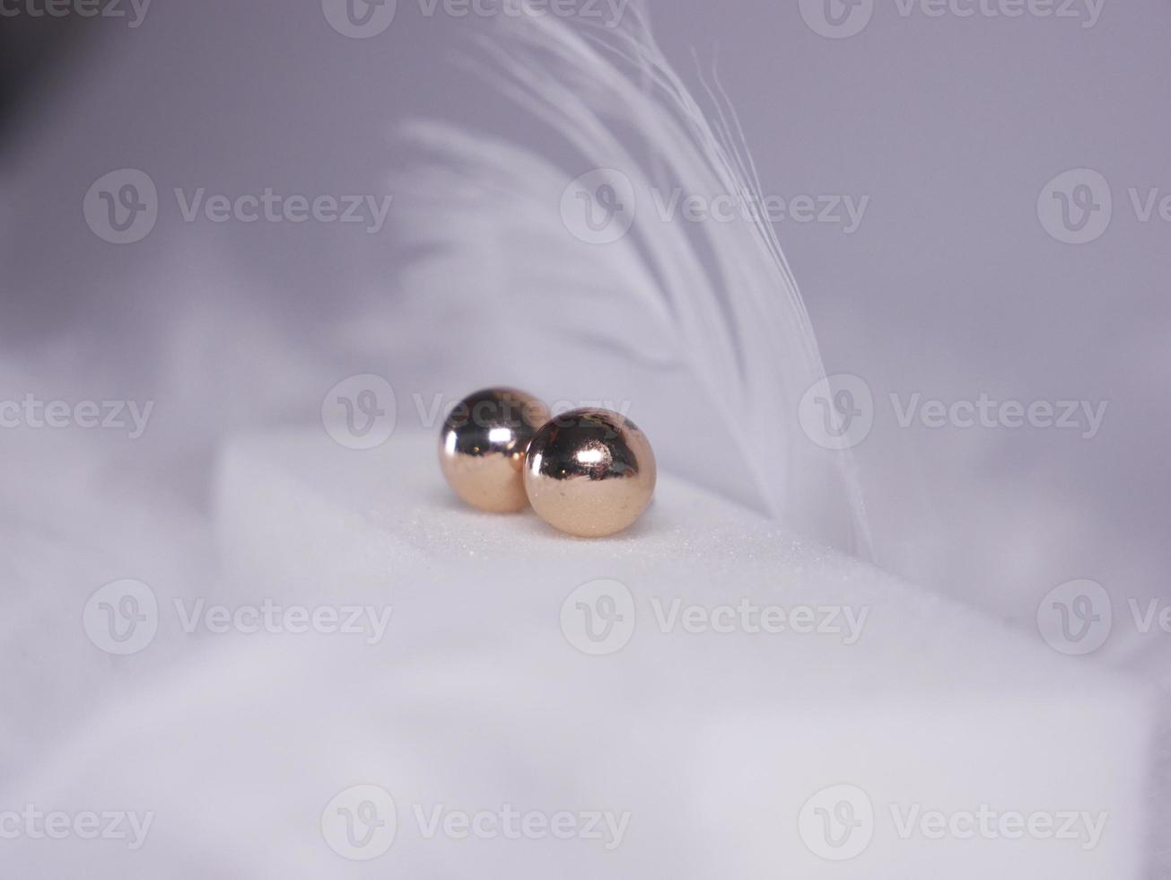 Beautiful gold earrings close-up on a white background photo