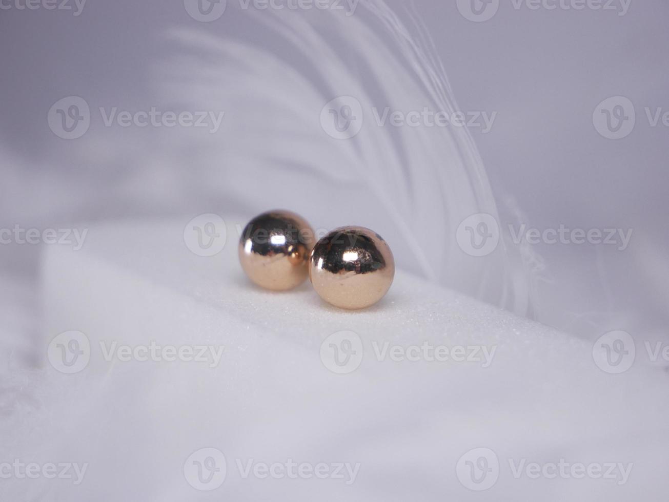 Beautiful gold earrings close-up on a white background photo