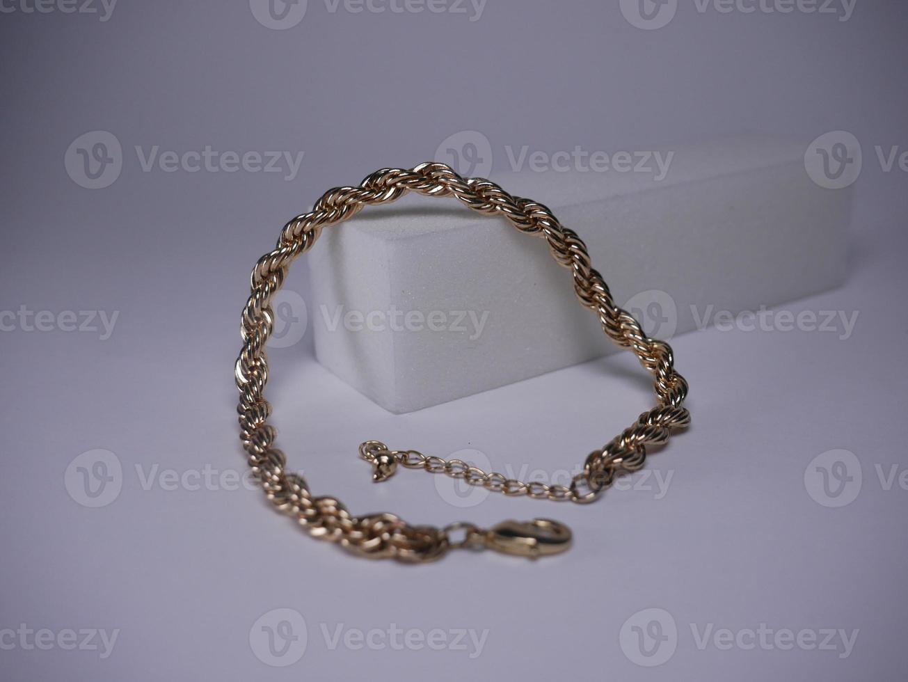 Golden bracelet shot close-up on a white background photo