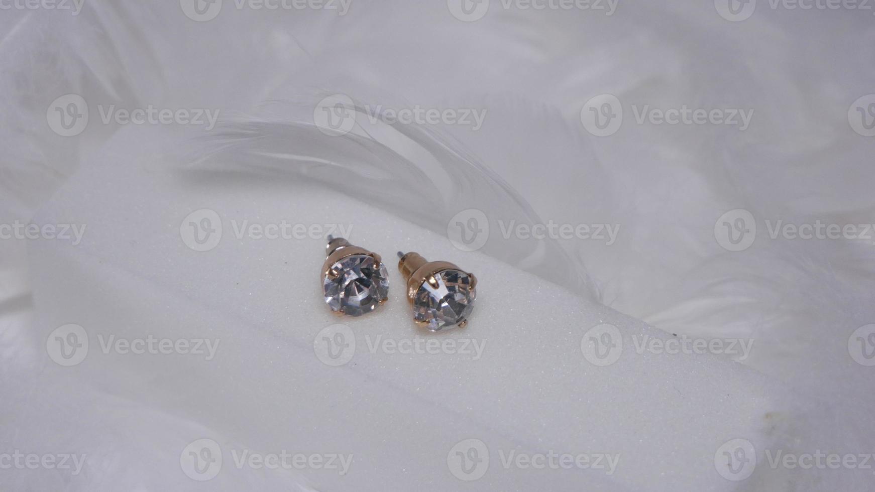 Beautiful gold earrings close-up on a white background photo