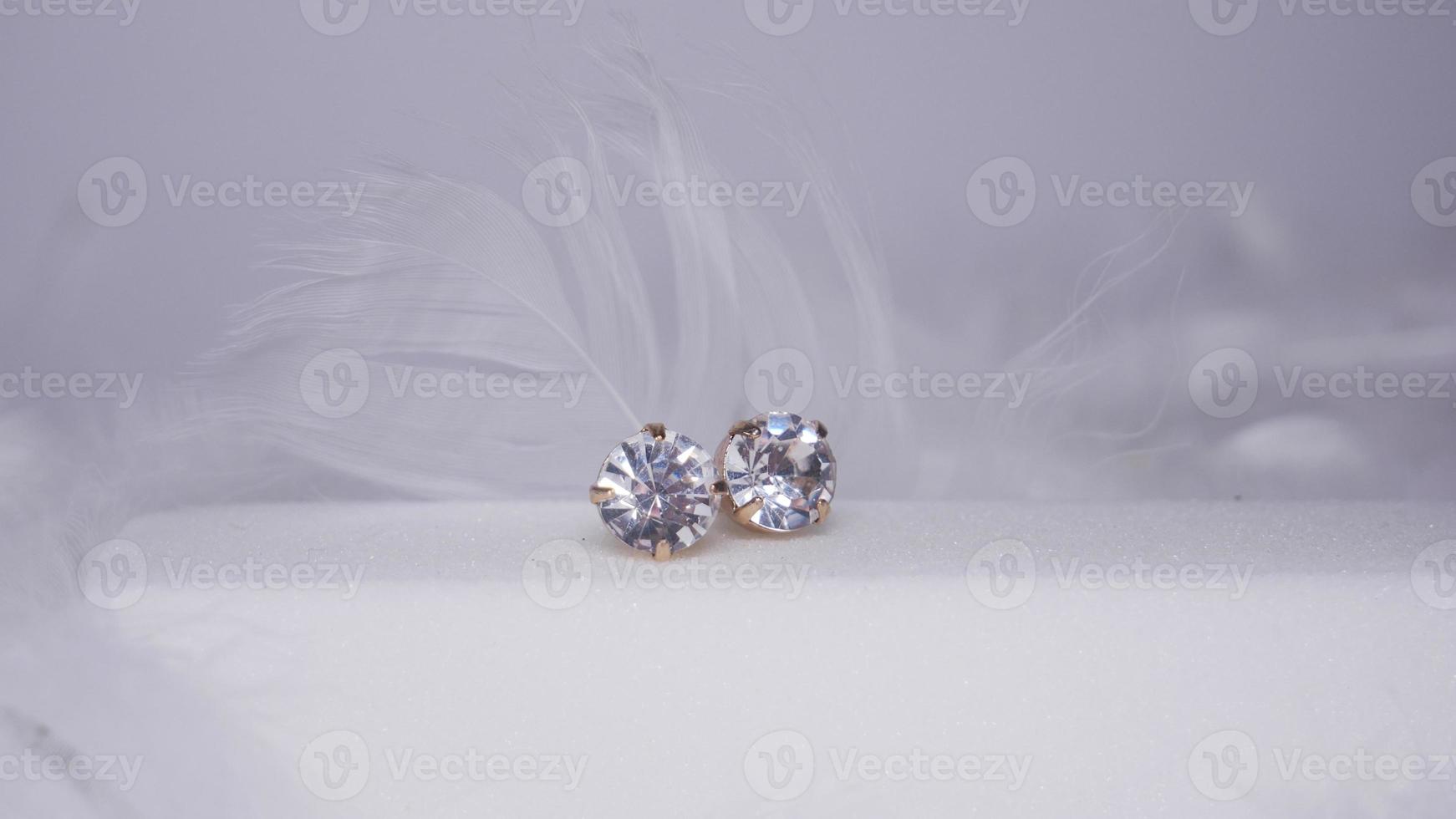 Beautiful gold earrings close-up on a white background photo