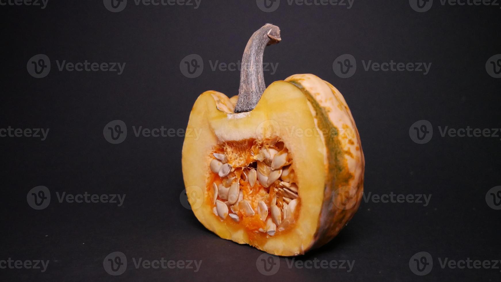 Ripe pumpkin on black background photo