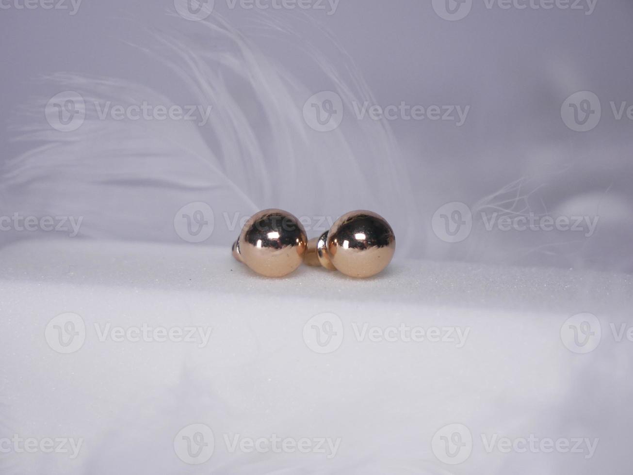 Beautiful gold earrings close-up on a white background photo