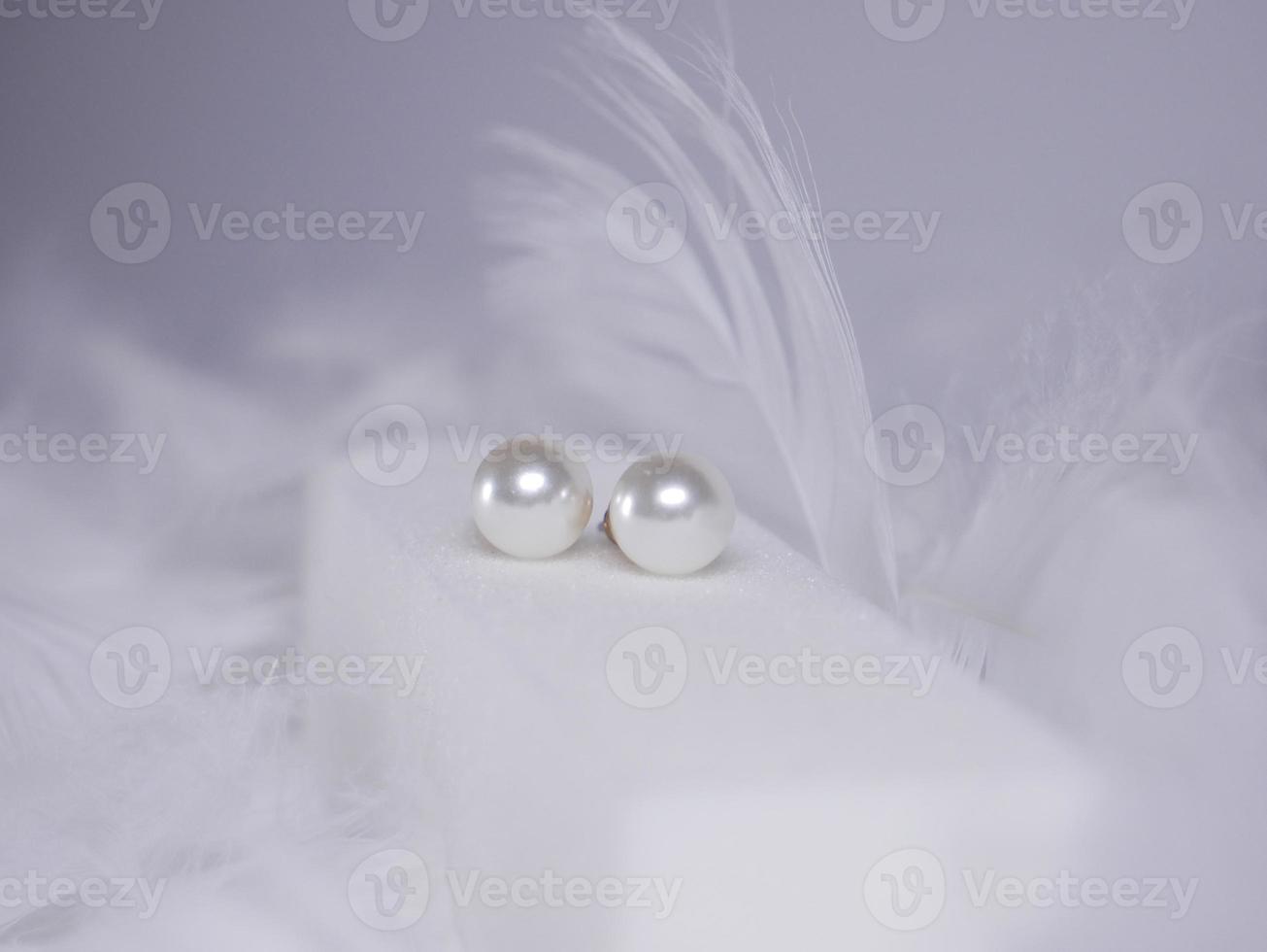 Beautiful gold earrings close-up on a white background photo