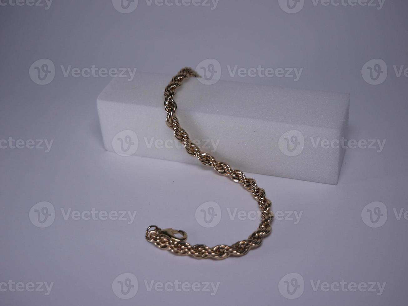 Golden bracelet shot close-up on a white background photo