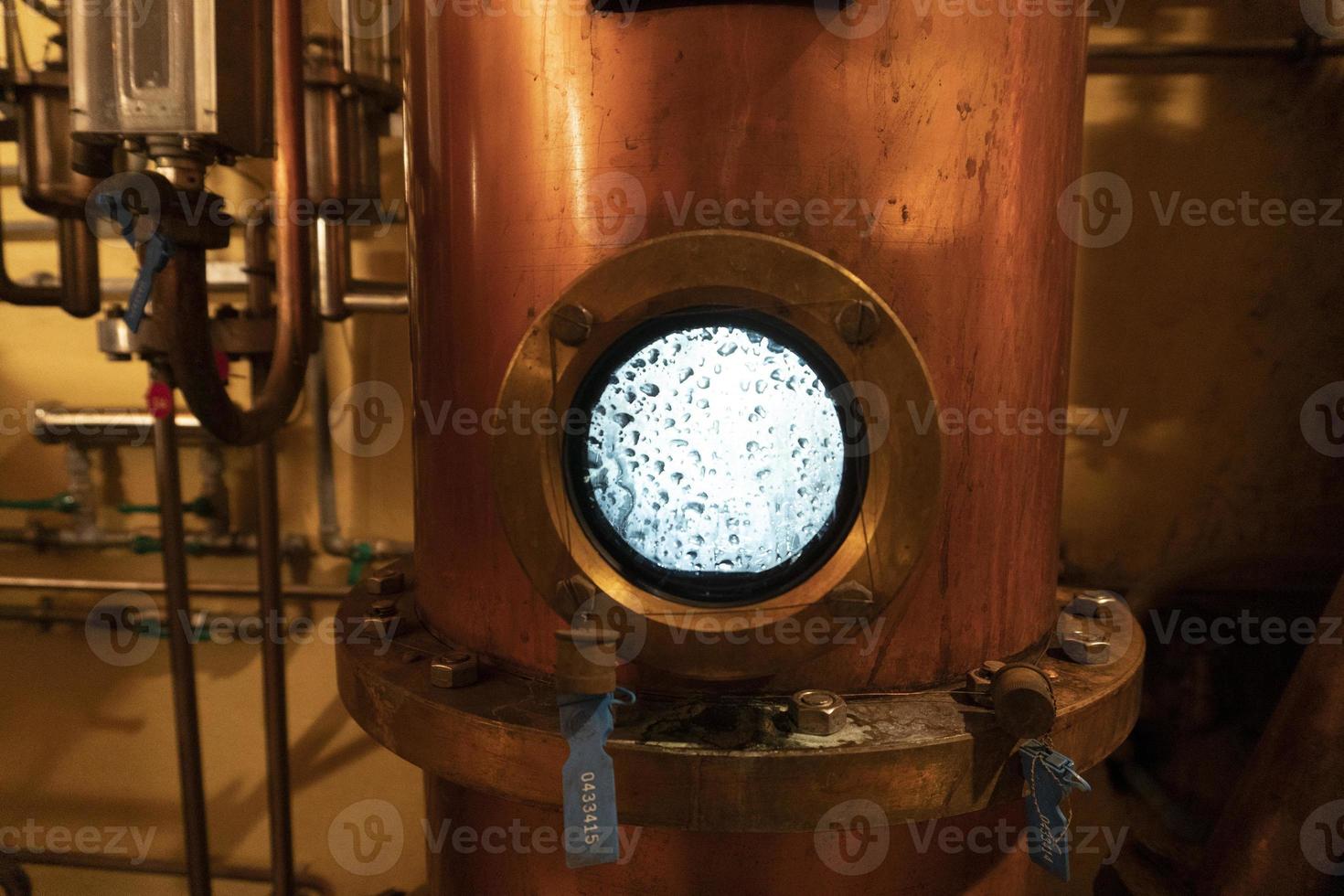 Copper alambic inside distillery photo