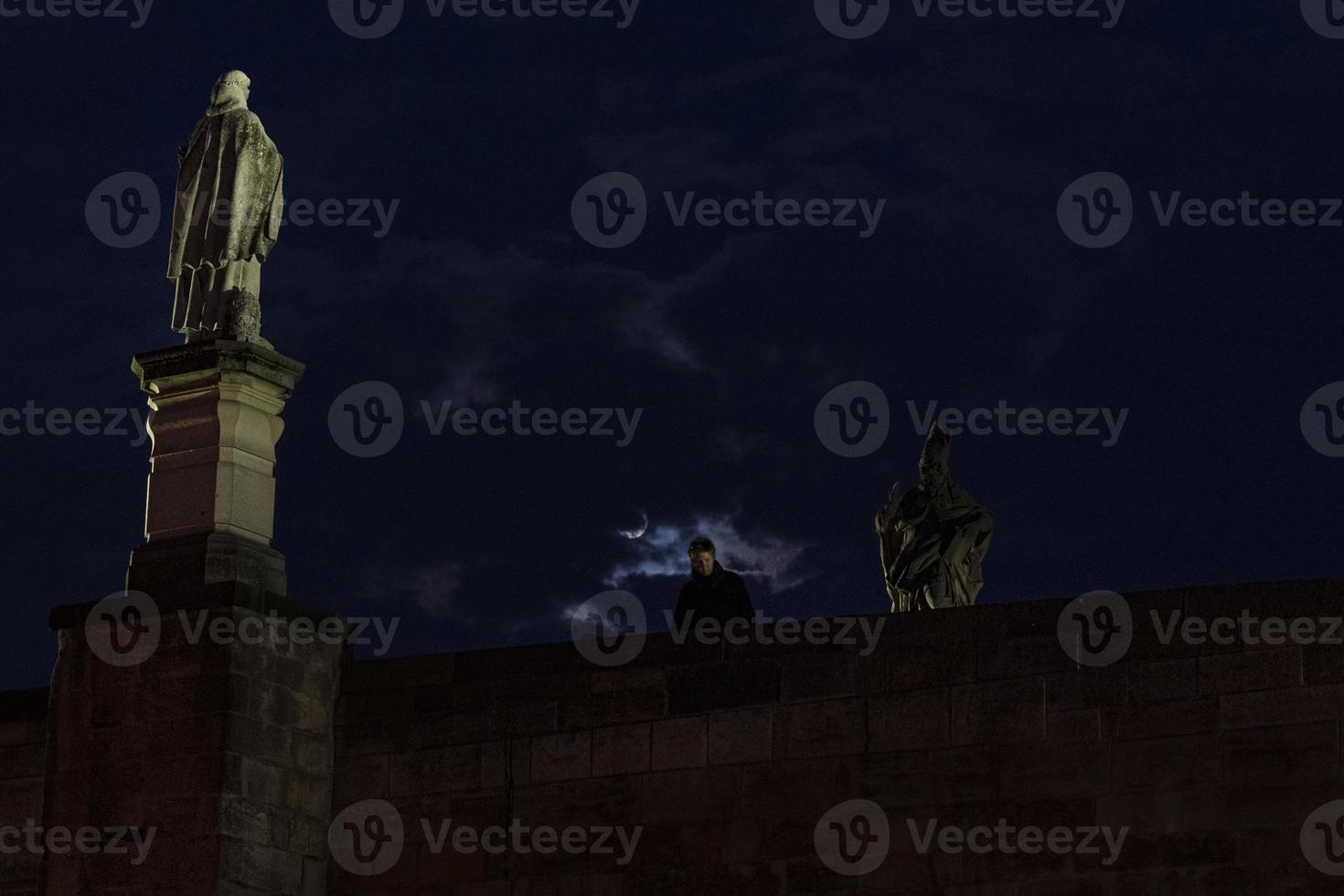 Prague charles bridge at moon light night photo