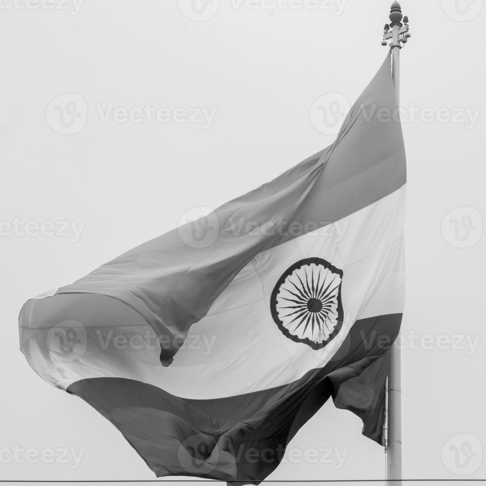 India flag flying high at Connaught Place with pride in blue sky, India flag fluttering, Indian Flag on Independence Day and Republic Day of India, tilt up shot, Waving Indian flag, Har Ghar Tiranga photo