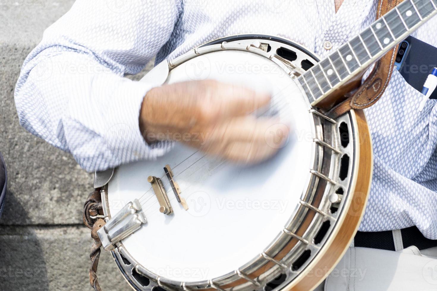 street artist playing banjo musician detail of hands photo