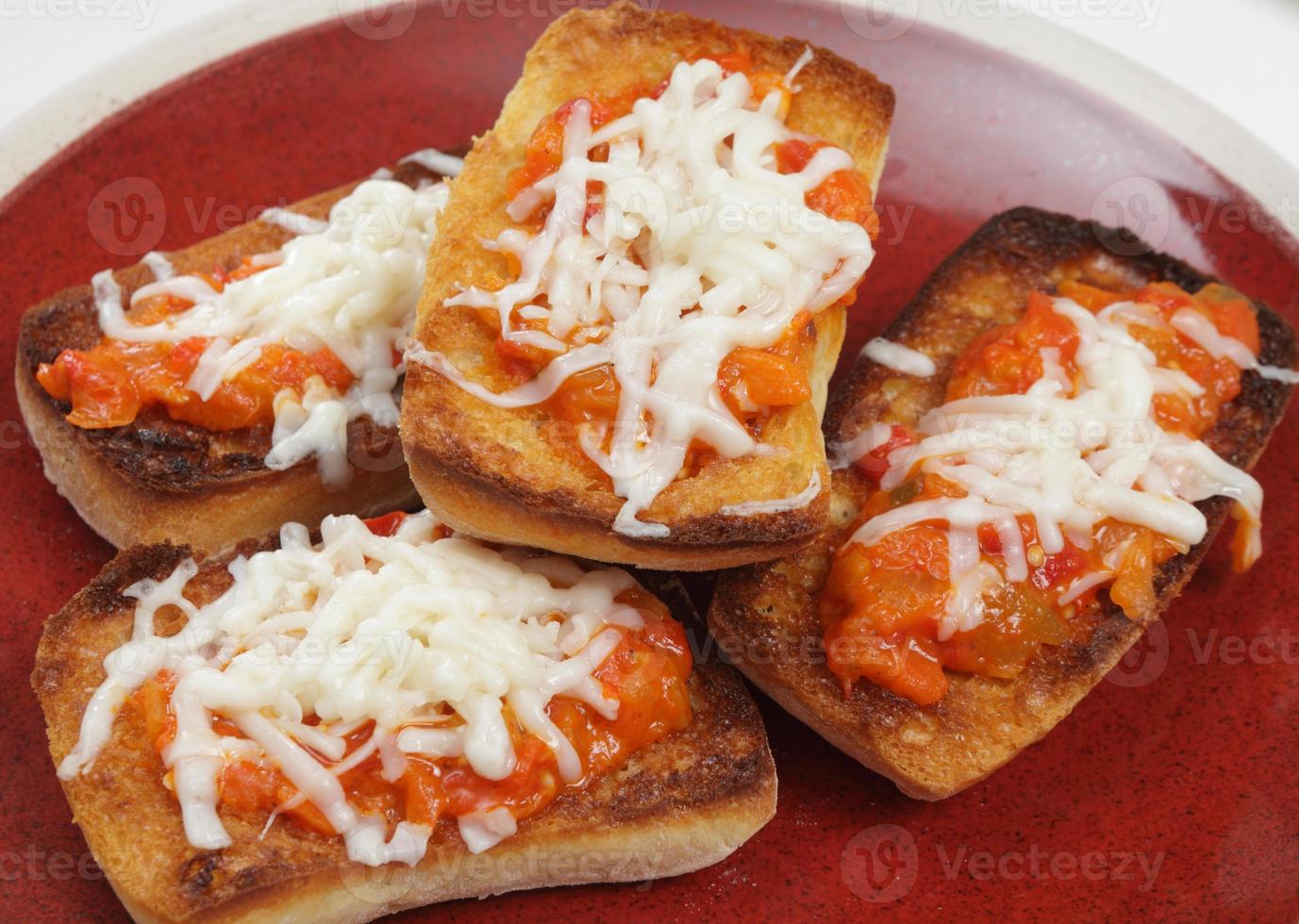 classic pizza with cheese on the table in a cafe on a wooden stand with a cut triangular piece and a pizza knife photo