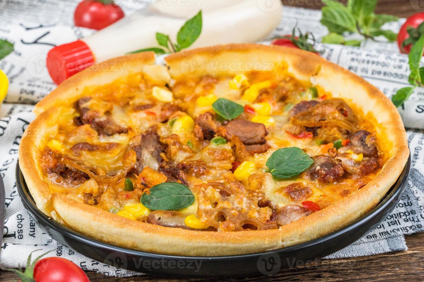 classic pizza with cheese on the table in a cafe on a wooden stand with a cut triangular piece and a pizza knife photo