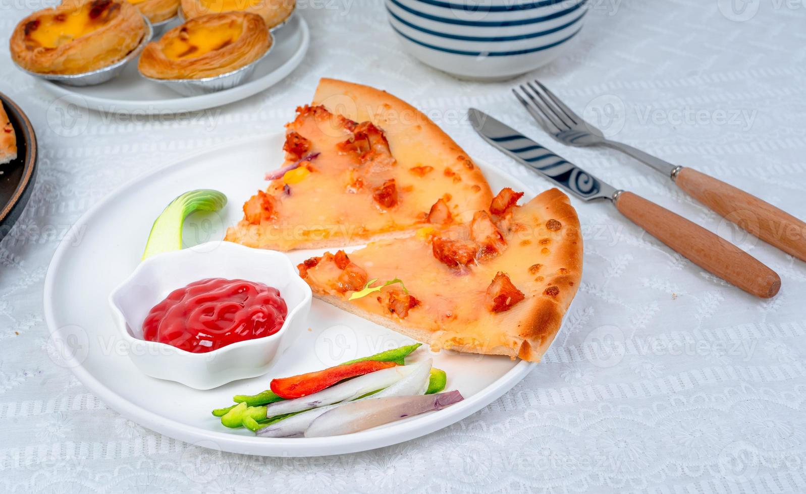 classic pizza with cheese on the table in a cafe on a wooden stand with a cut triangular piece and a pizza knife photo