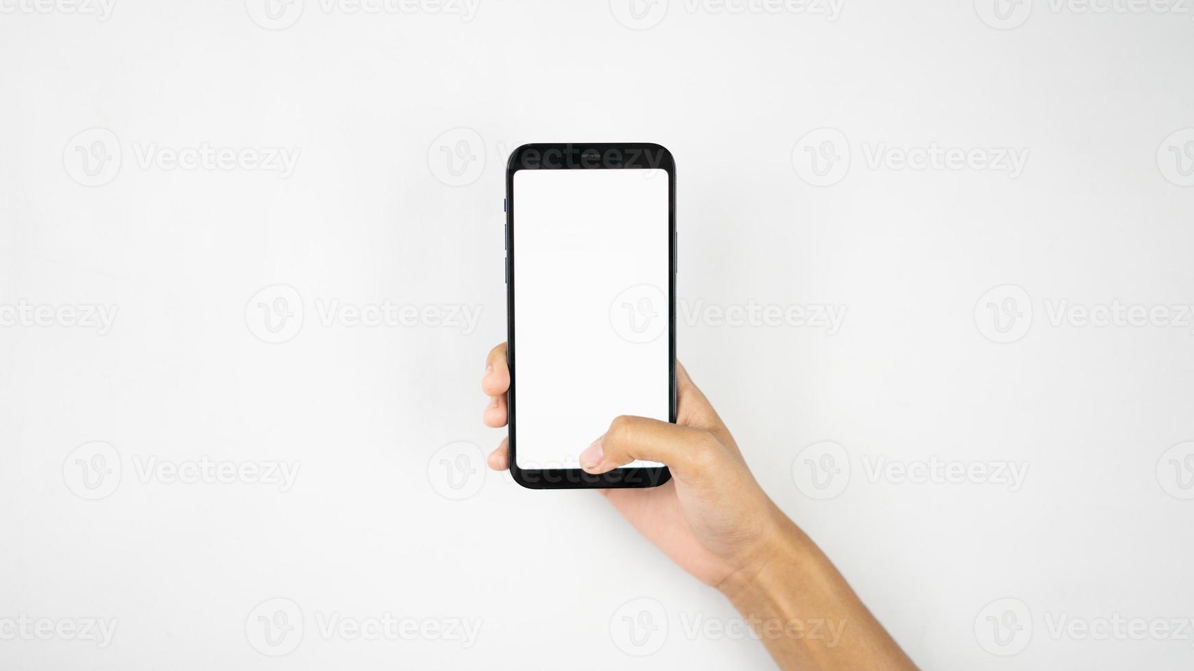 Hand holding blank smartphone for mockups photo