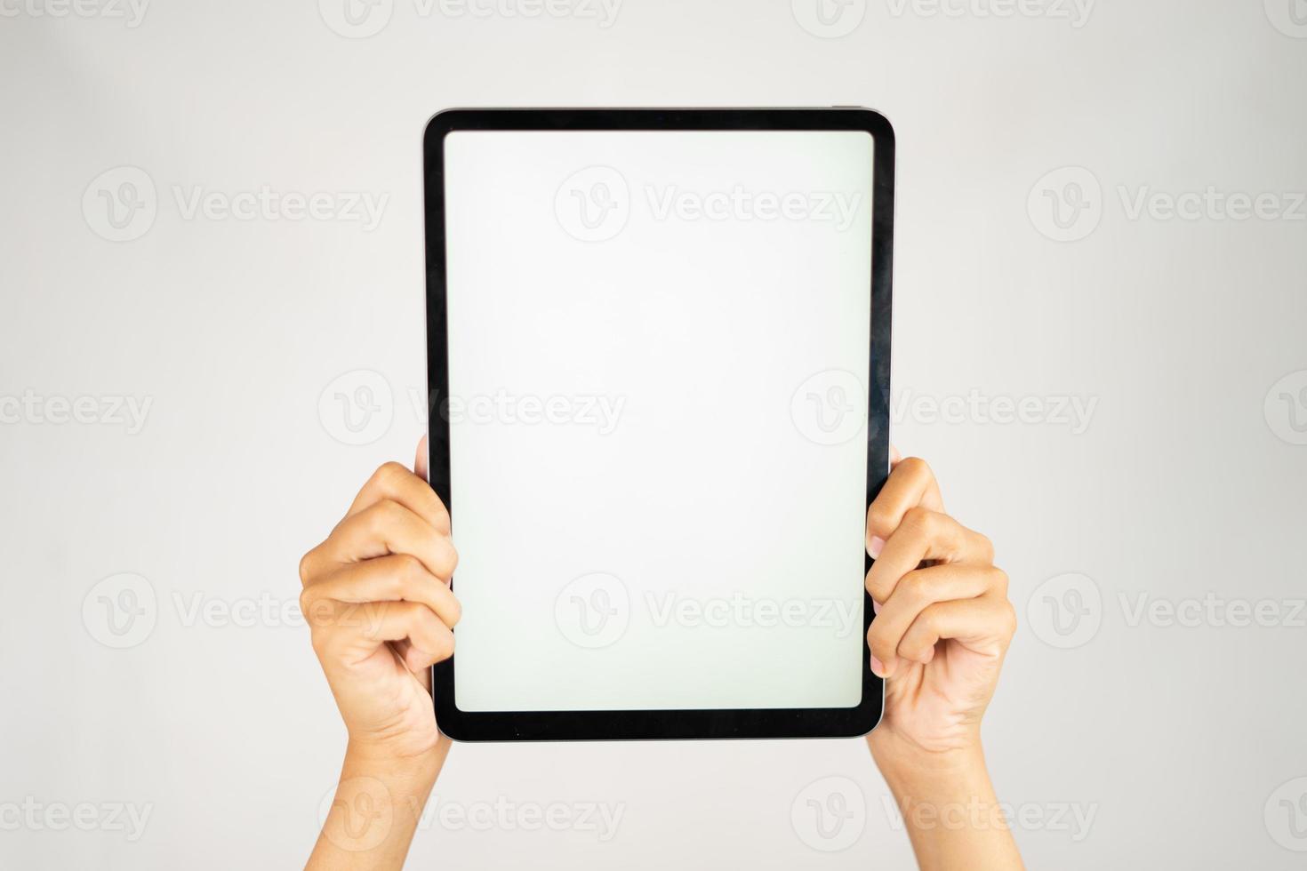 Two hands holding blank screen tablet for mockups photo