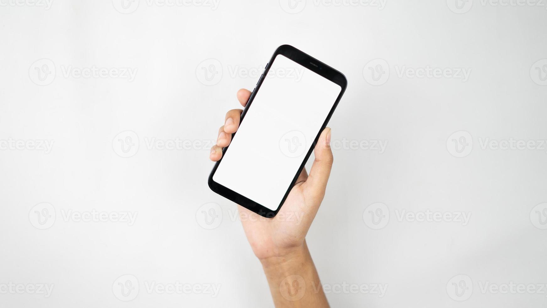 Hand holding smartphone for interface mockup photo