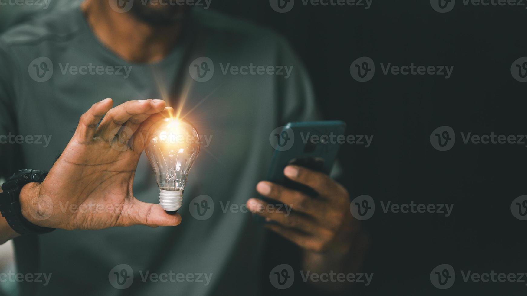 Idea innovation and inspiration concept. Hand of man holding illuminated light bulb, concept creativity with bulbs that shine glitter. Inspiration of ideas for sustainable business development. photo