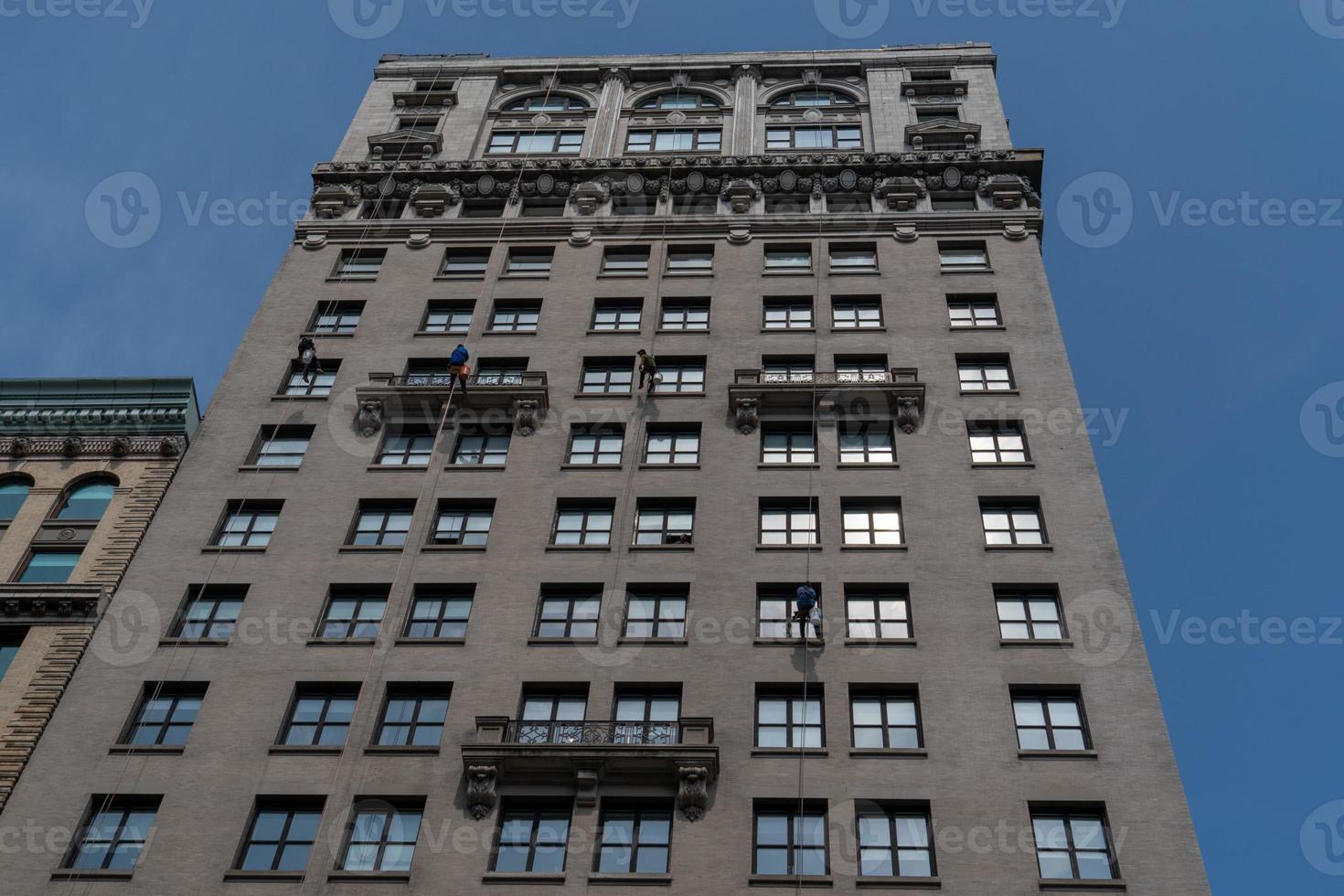 Window cleaners climbing skyscraper in New York photo