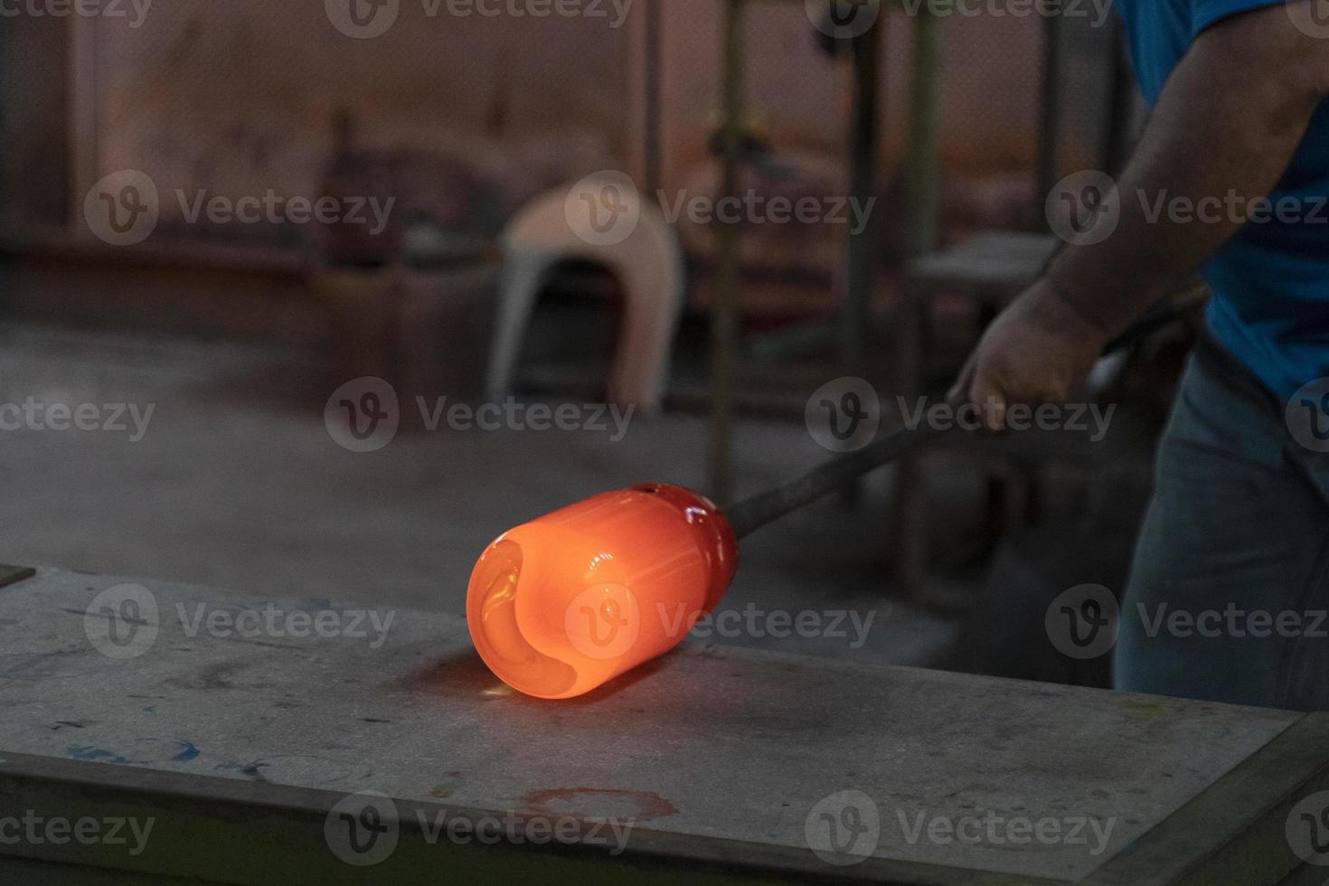 glass master while working in Murano furnace glass factory Venice Italy photo