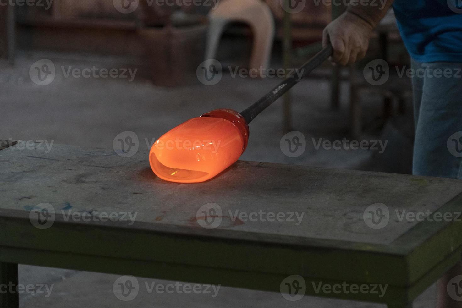 glass master while working in Murano furnace glass factory Venice Italy photo
