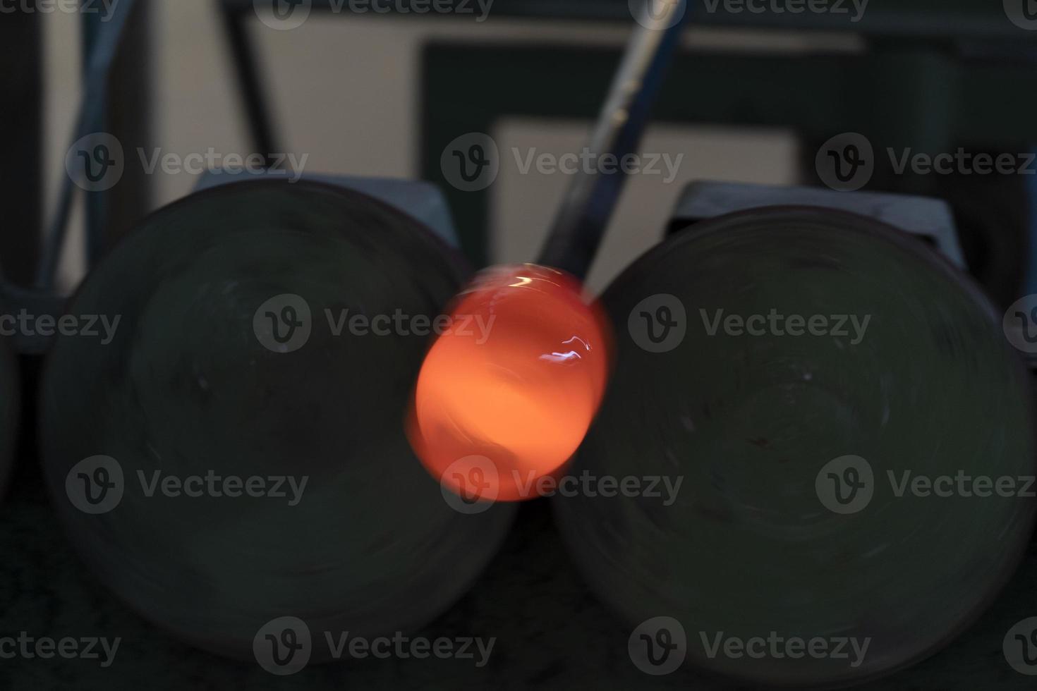 glass master while working in Murano furnace glass factory Venice Italy photo