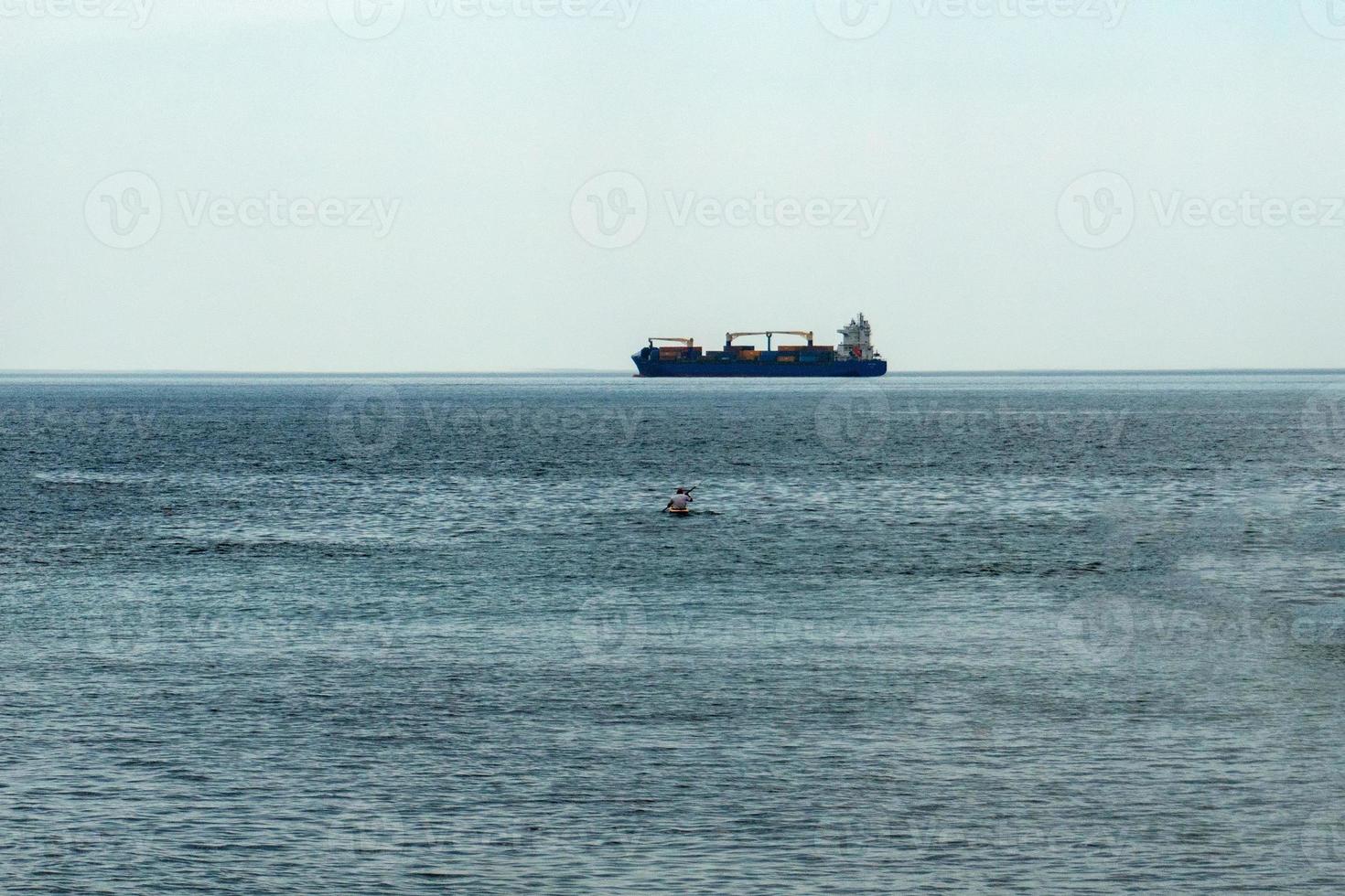 canoe and big ship photo