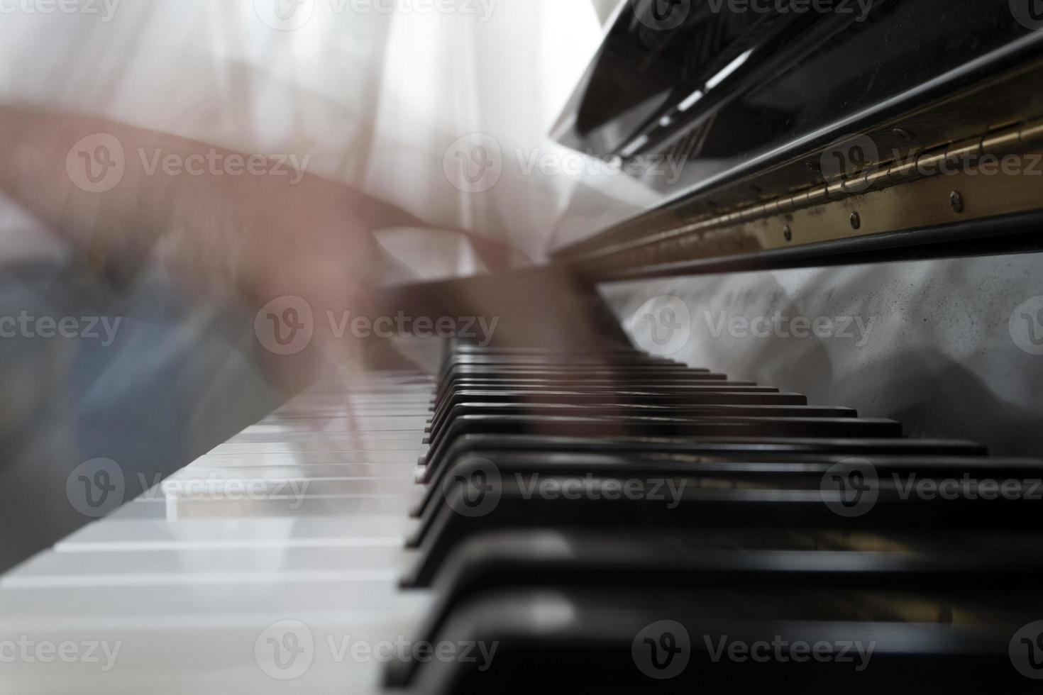 Hands playing piano while moving photo