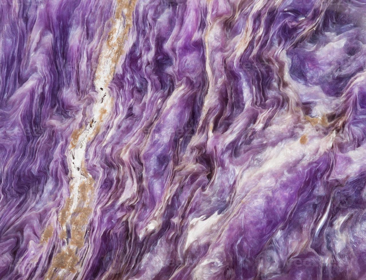background from tumbled charoite gemstone photo