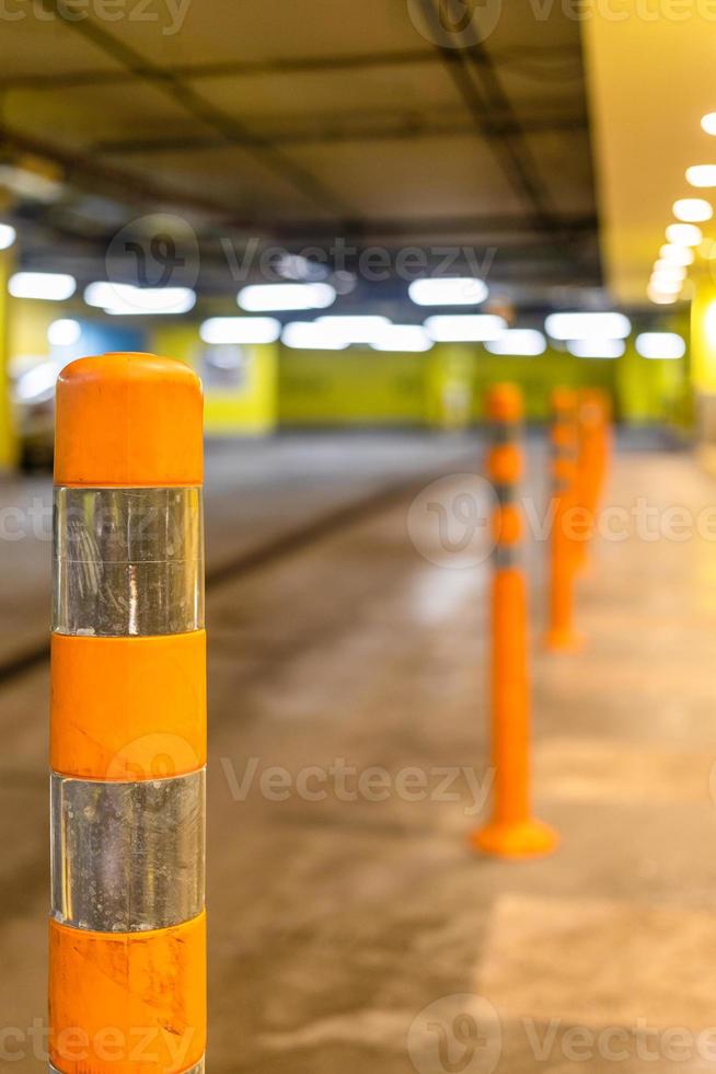 orange security bollard in underground parking photo