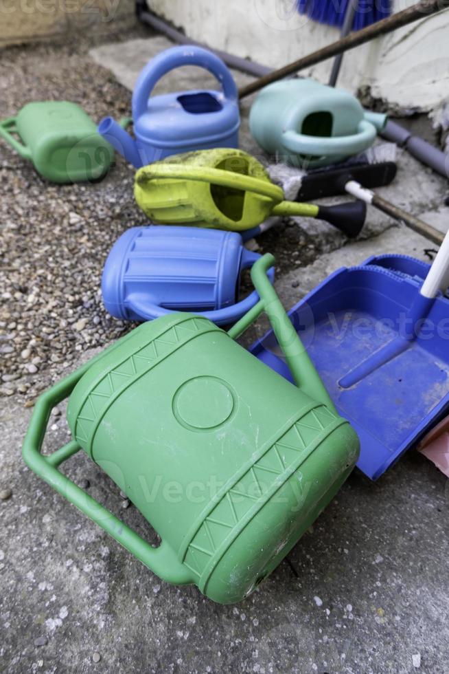 Colored plastic watering cans photo