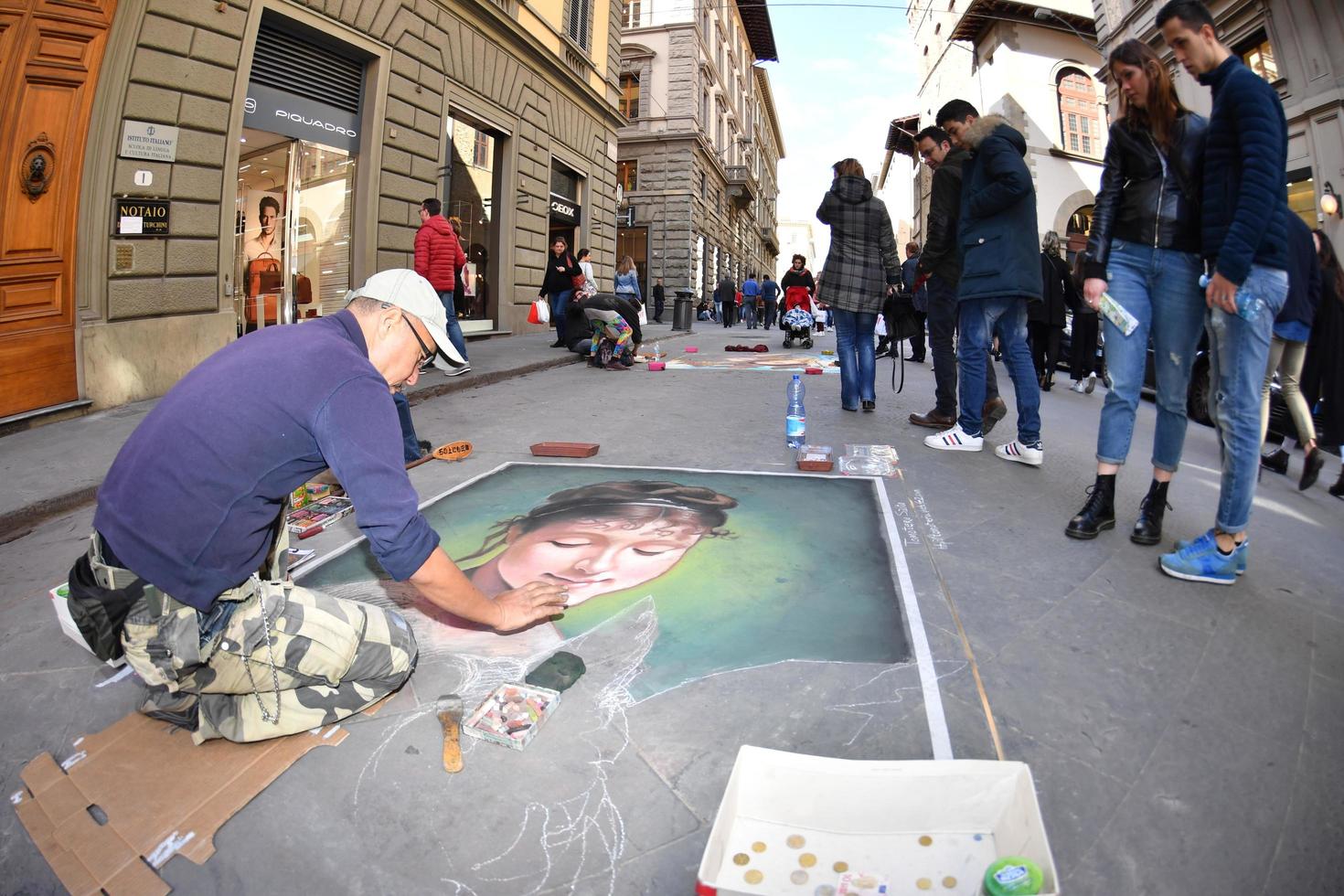 FLORENCE, ITALY - MARCH 27 2017 - Pavement artist painting on the streets photo