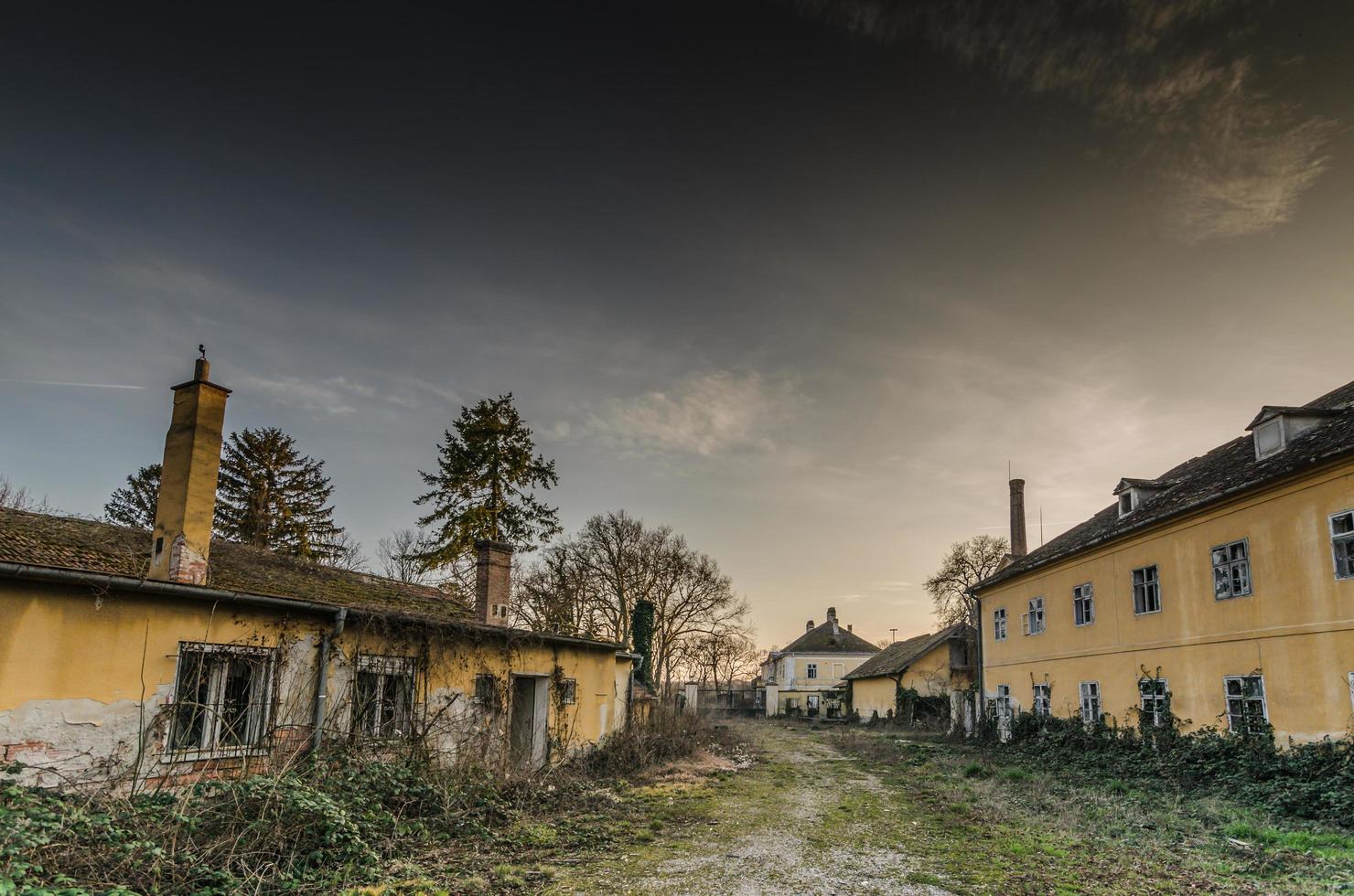 abandoned village with old yellow houses photo