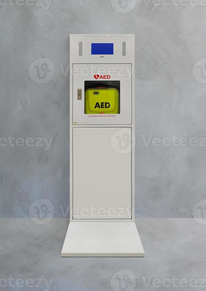 Automatic electric defibrillator isolated on cement background photo