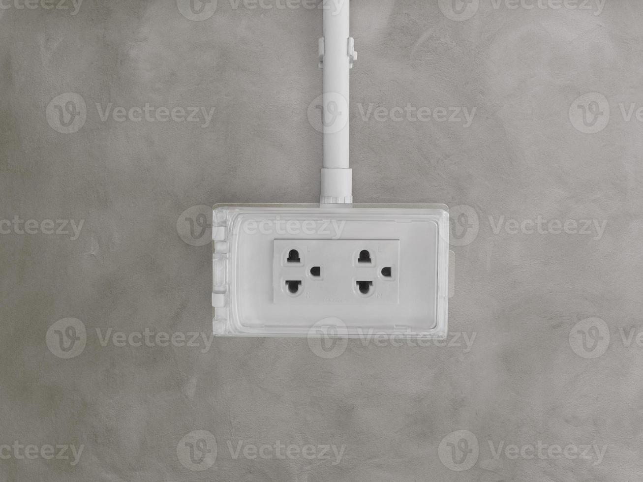 Electrical outlet boxes with covers on concrete walls for using outside the home electrical system. photo