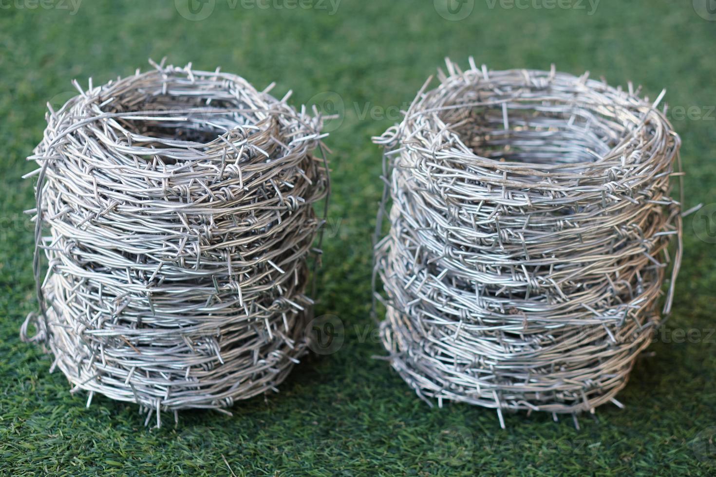 Rolls of barbed wire. Barbed wire is used for make fences , secure property and make border to show the territory of  area. photo