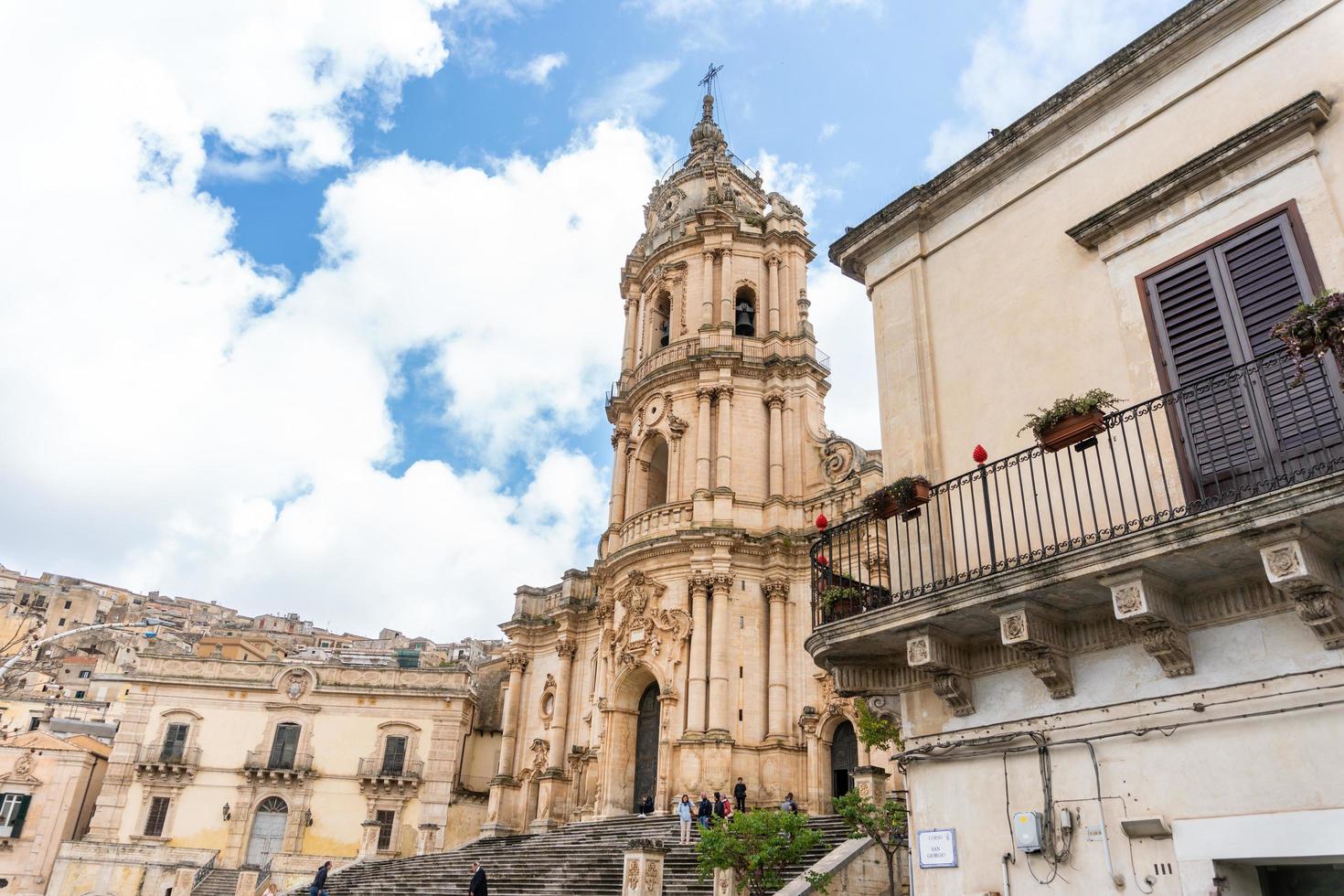 Modica, Italy-May 8, 2022-Panoramic view of the characteristic city of Modica and its cathedral of San Giorgio in Sicily during a cloudy day photo